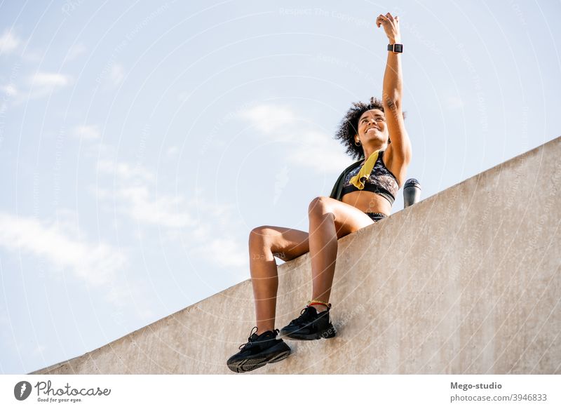 Afro athlete woman flexing and showing muscles. Stock Photo by megostudio