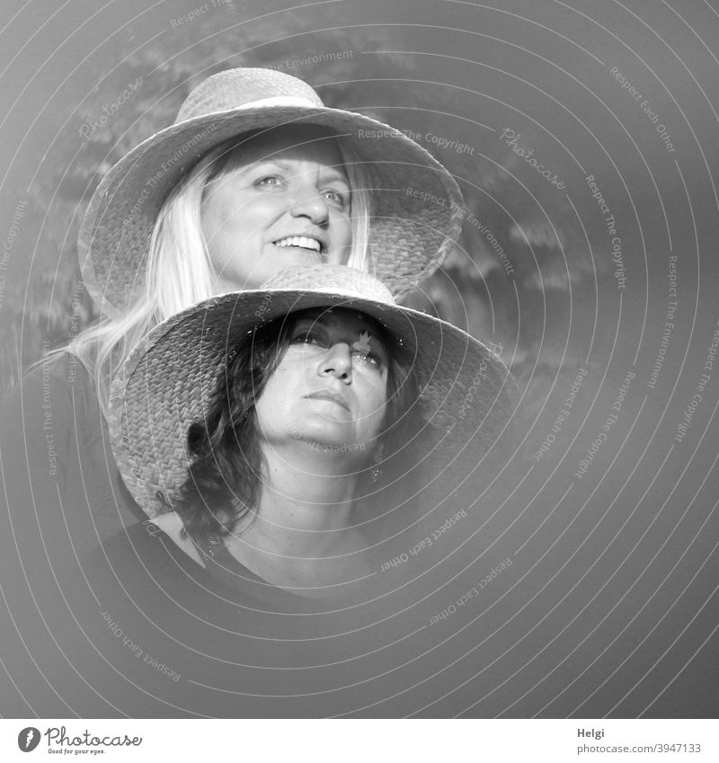 Faces of two ladies in straw hats, one looking up seriously, the other looking forward with a smile Human being Lady Woman Straw hat Long-haired Blonde Brunette