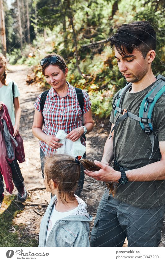 Family Hiking In Mountains On Summer Vacation Stock Photo