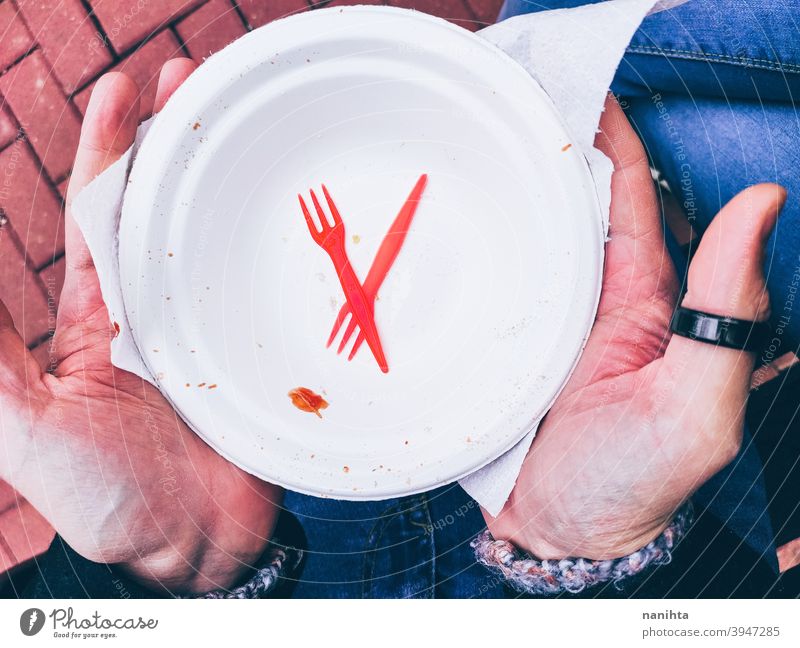 Disposable plate and cutlery disposable dish empty single use trash knife plastic microplastic fork hold holding picnic hands man male young no sustainable