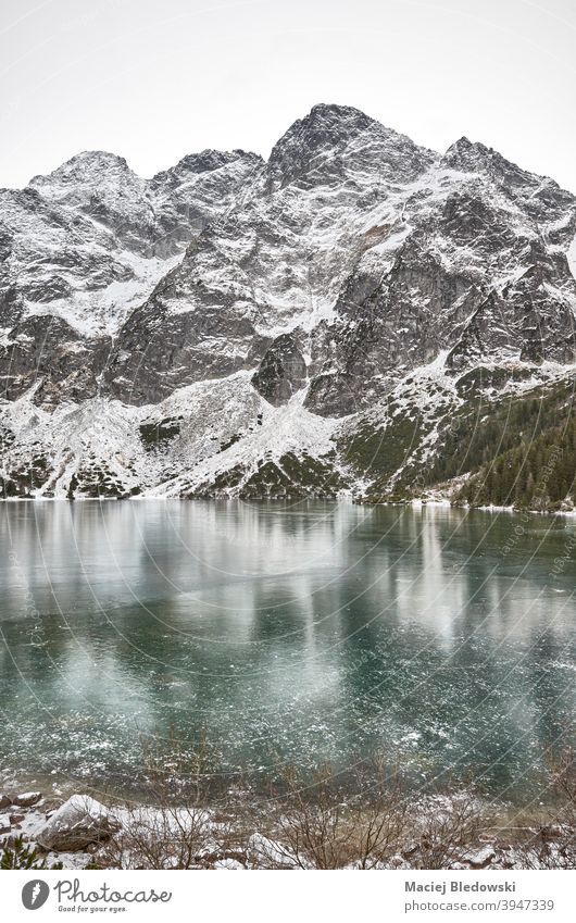 Frozen lake on a snowy day in Tatra National Park, Poland. winter landscape mountains Morskie Oko Eye of the Sea ice beautiful Tatry cold wilderness sky outdoor