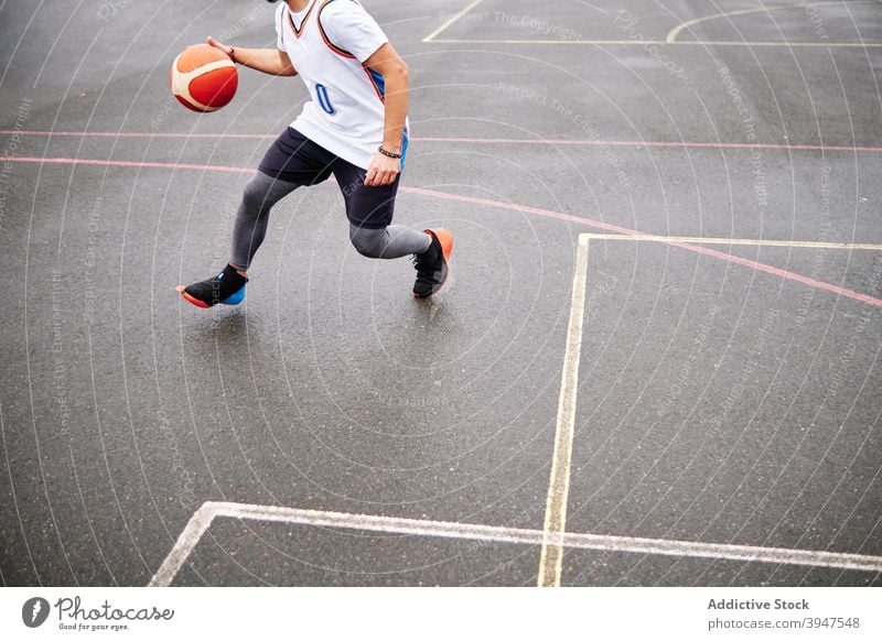 Cropped image of male playing basketball at a court. Copy Space. score winner dribble succeed youth uniform player strength physical competitive support