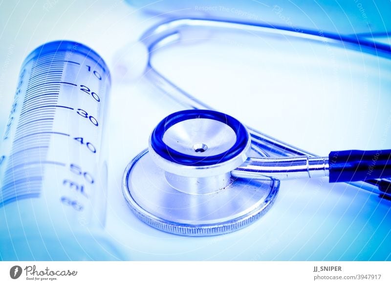 A stethoscope in front of medical antibiotic background bottle capsule clinical close up closeup crop cure diagnose diagnosis diagnostic disease doctor drugs