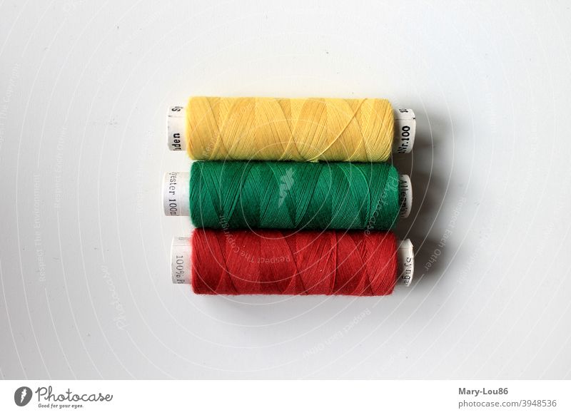 Yellow, green and red thread spool Thread rolls Sewing colors colourful Green Red Craft (trade) Multicoloured Close-up white background Copy Space top