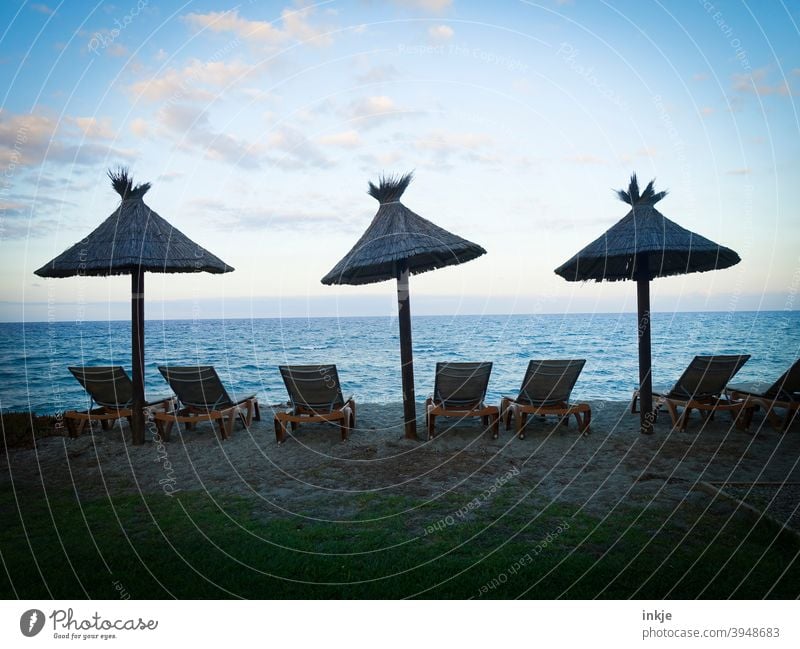 S E H N S U C H T lockdown Colour photo Ocean Horizon evening mood parasols Beach Lie Deserted Blue Beautiful weather holidays free time vacation Off-Season