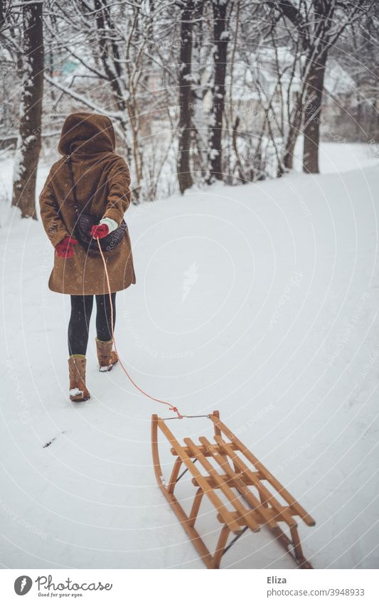 A woman pulls a sled through the snow. Winter atmosphere. Sleigh Pull Landscape wood sledges winter landscape Snow Winter mood Snowscape Woman Cold out Nature
