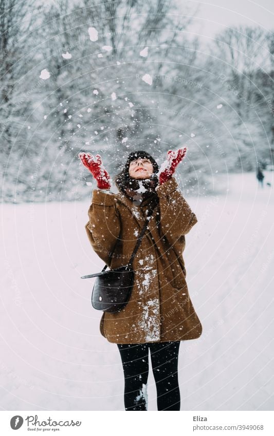 Woman throws snow in winter Snow Winter Throw Joy Snowscape snowy Nature out Cold White Winter mood Winter forest Winter's day Gloves Coat youthful