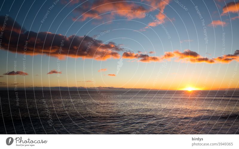 Sunset over the Atlantic Ocean. Evening atmosphere with scattered clouds, sunlight .sun on the horizont Sunrise Horizon sunset Sunlight Reflection calm sea