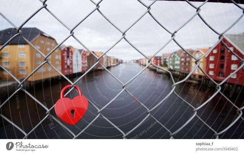 love lock, heart padlock on bridge fence in Trondheim river forever relationship couple honeymoon romance travel romantic city trip tradition trondheim