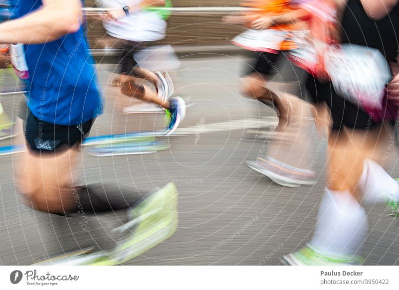 blurred marathon runner on an asphalt road Marathon Runner jogging shoes Speed Endurance Jogging Running Jogger Movement Exterior shot competition Athletic