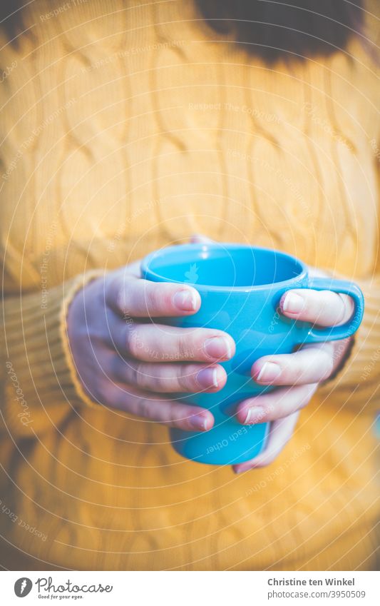 Turquoise coffee mug held by hands of young woman in yellow pigtail sweater Coffee mug Hot drink Beverage Coffee cup Coffee break To hold on warming Cup stop