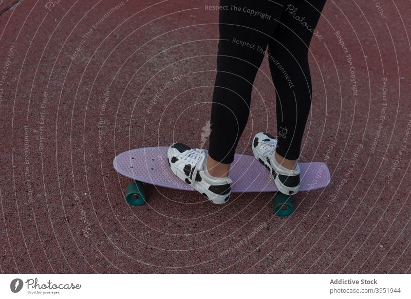 Unrecognizable skater with penny board during workout woman walk sports ground training ride balance hobby active energy practice female young teenage trendy