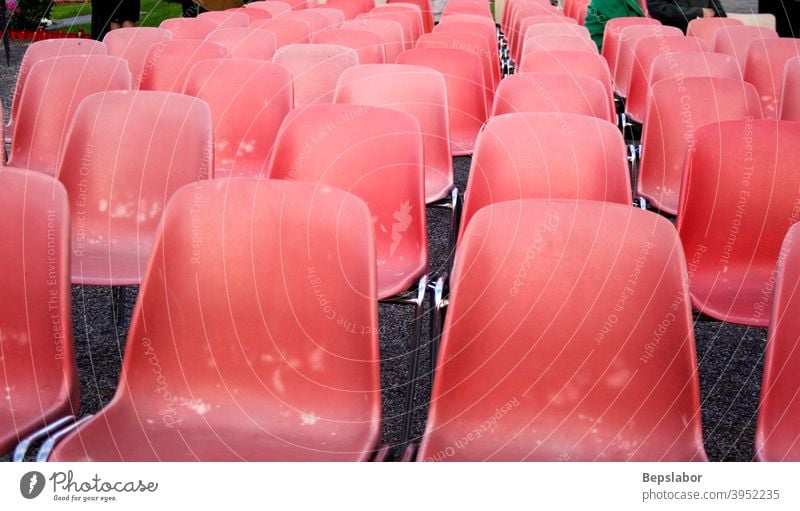 Red old plastic chairs row seat closeup audience conference furniture perspective seating spectator empty event many public line nobody object outdoors red
