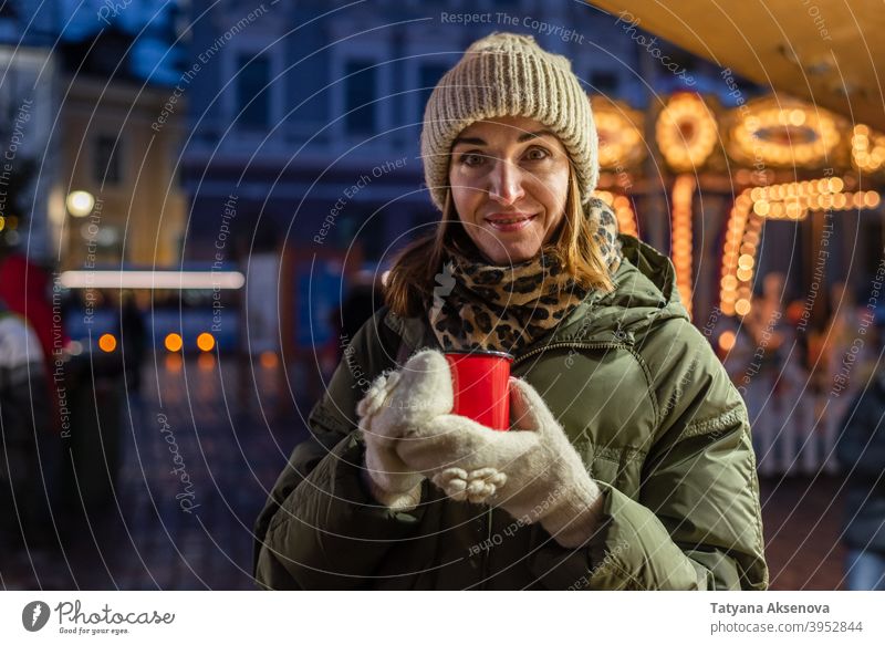 Woman drinking on Christmas market christmas woman cup holiday christmas market mulled wine hot drink winter outdoor person adult female december light cheerful
