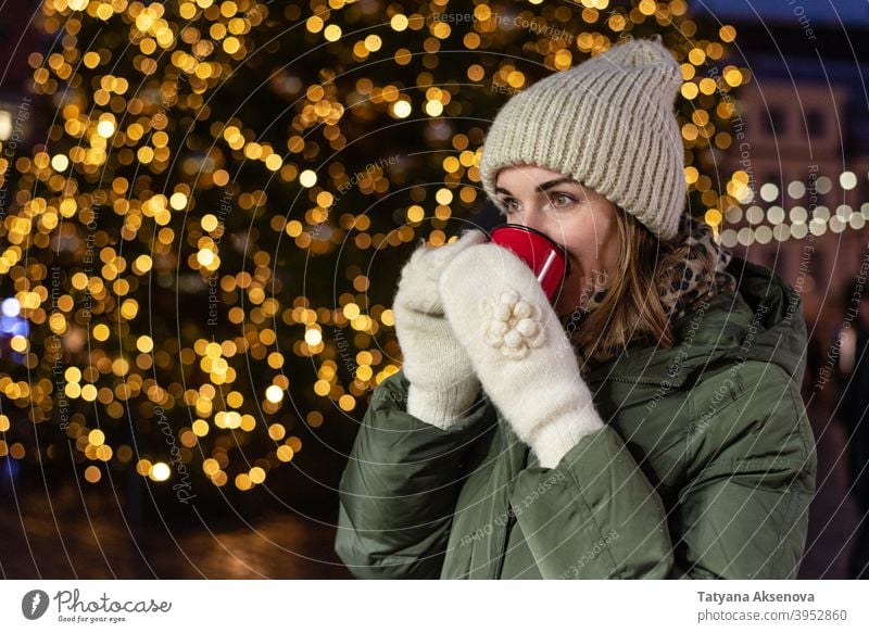 Woman drinking on Christmas market christmas woman cup holiday christmas market mulled wine hot drink winter outdoor person adult female december light cheerful