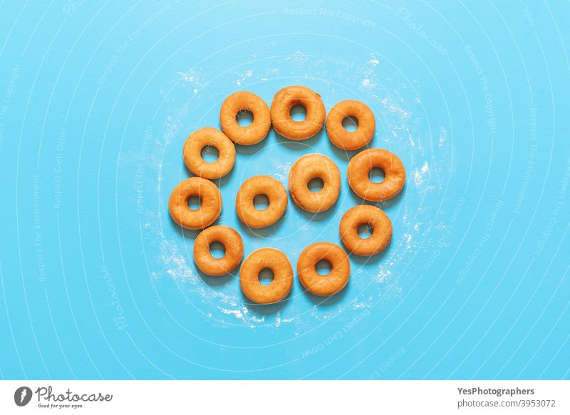 Donuts aligned in a circle shape. Homemade fresh doughnuts, top view american baked bakery blue background breakfast cake calories comfort food confectionery
