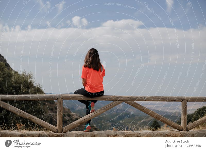 Woman resting on fence against mountains woman traveler explore highland scenery nature adventure spectacular female tourist spain grazalema admire freedom