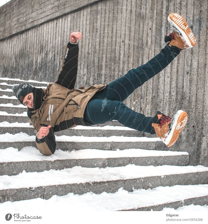 Man slip on ice and falling down stairs - a Royalty Free Stock