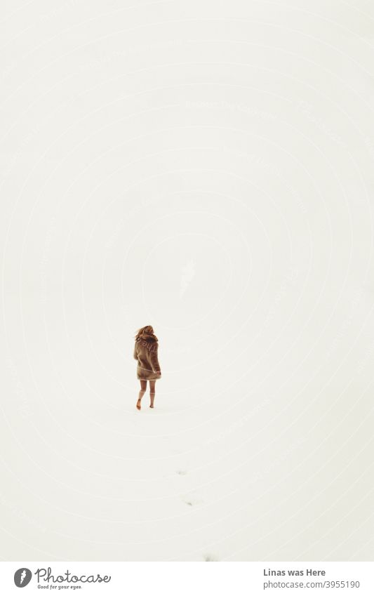 All is white, all is bright. Endless snowy fields are all you can see in the winter horizons. And a barefoot girl running into the wilderness. Dressed in brown fur and with no pants, she is leaving her traces in the cold snow.