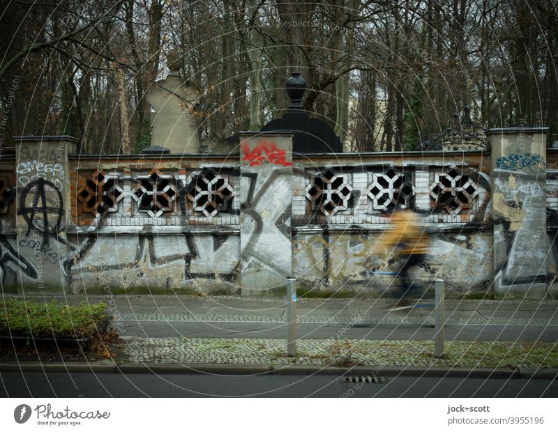 (All nearly) dead cemetery wall Wall (barrier) Cemetery Jewish cemetery Schönhauser Allee Prenzlauer Berg Cycle path cyclist motion blur Mobility Historic
