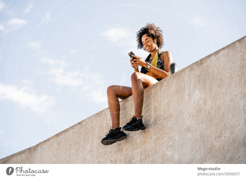 Afro athlete woman flexing and showing muscles. Stock Photo by megostudio