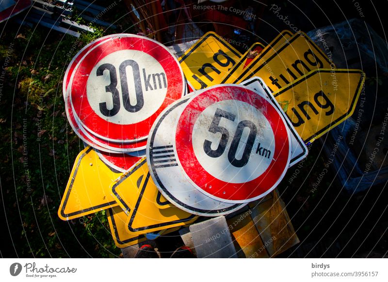 Many traffic signs are lying on top of each other on the ground, speed limit 30 km/h, 50 km/h, diversion Traffic signs Speed limit Diversion Urban transport