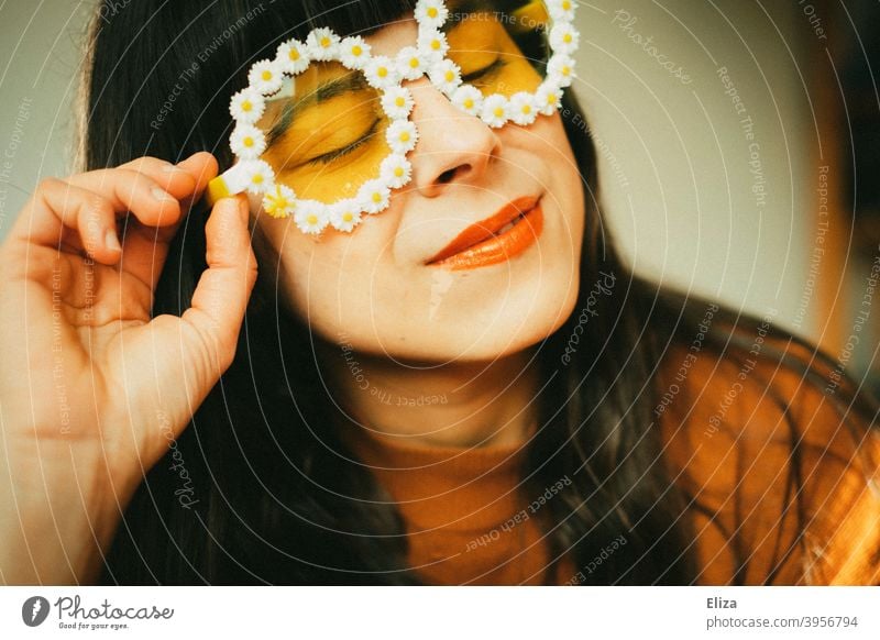 Woman with flower sunglasses in the sunlight. Retro mood, optimism good mood and summer. Sunglasses Optimism summer atmosphere Spring sunshine little flowers