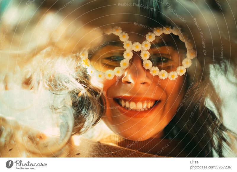 Smiling woman in funny flower sunglasses looks at the camera bent forward Woman Sunglasses little flowers Good mood Joy Eyeglasses Hippie leaning over look down