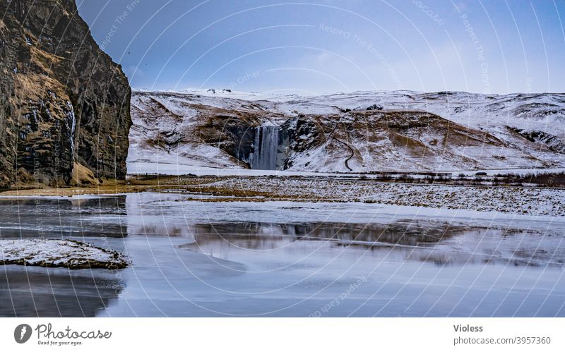 Skógafoss waterfall in Iceland Waterfall Exterior shot Colour photo naturally Rock Hill Gale Wind Weather Clouds Sky Landscape Nature Shadow Light Rain Snow