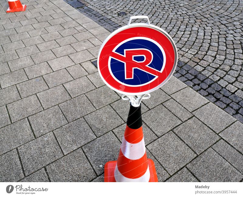 Portable unofficial traffic sign for no parking and no stopping on a Lübeck hat on grey pavement Transport Road sign No Parking No standing Road traffic cordon