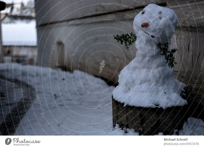 Snowman on a planting ring on a house wall Winter Cold White Exterior shot Playing Frost