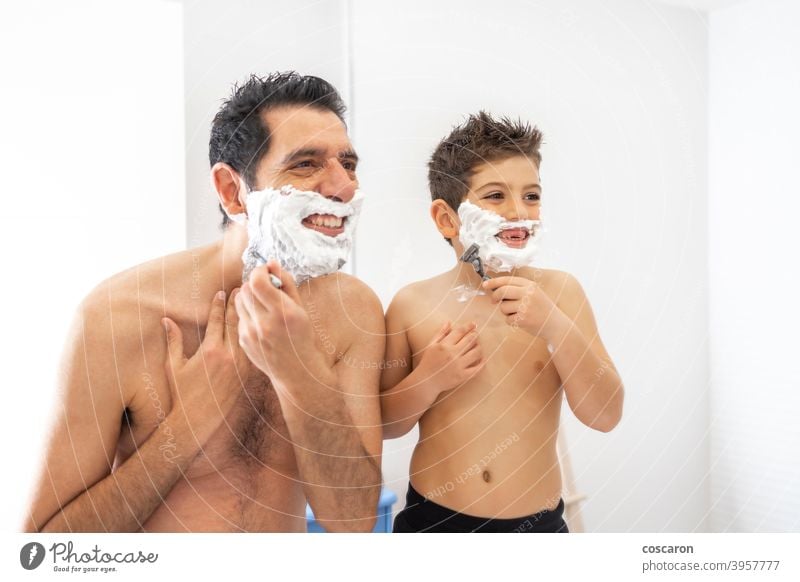 Funny father and son shaving in the bathroom adult bonding boy child childhood cream dad dad and son daddy day elementary face family fatherhood foam fun funny