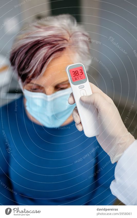 Free Photo  Medical thermometer indicating high temperature on the face  masks-coronavirus