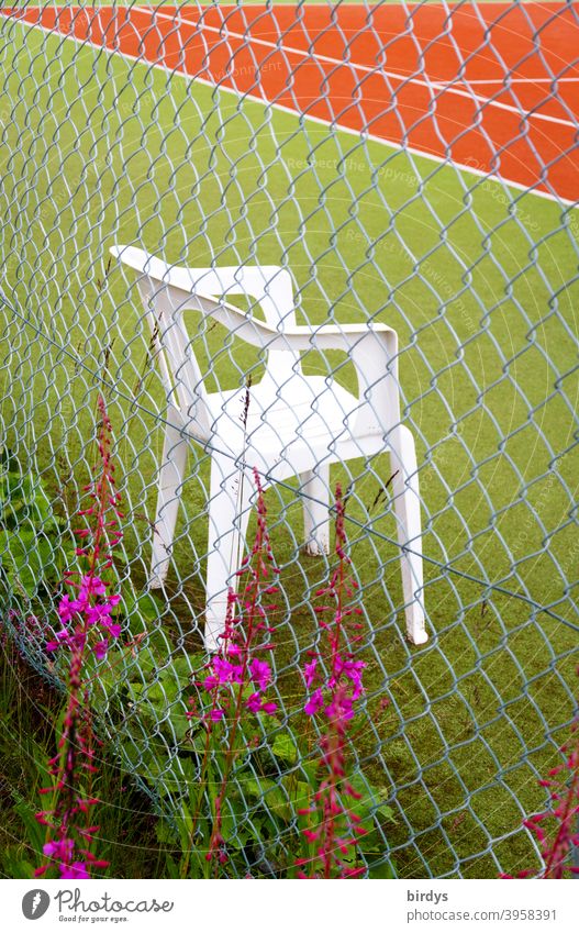 Empty chair at a tennis court behind a razor wire fence. sports site Tennis Tennis court Chair Fence Deserted lockdown pandemic corona orphan prevention