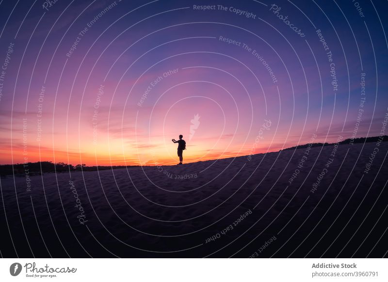 Unrecognizable traveler taking photo of sunset on beach take photo tourist silhouette sand sky summer sundown cadiz andalucia spain serene evening dusk memory