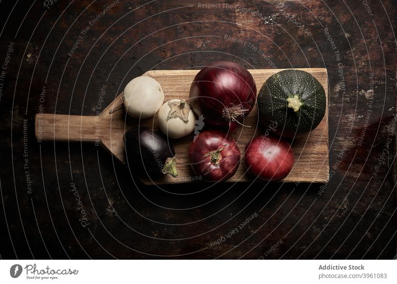 Top view of assorted vegetables on worn brown background food tomatoes cucumber eggplant pomodoro vegetarian raw healthy red onion organic ingredient purple