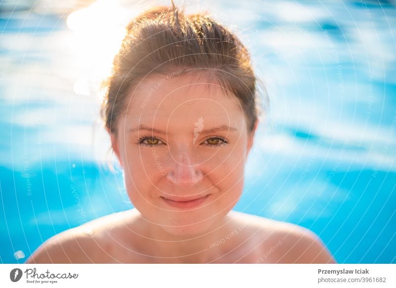 Young woman portrait in swimming pool. fashion candid spa water looking person girl authentic eyes summer face sun bikini caucasian beautiful lifestyle healthy