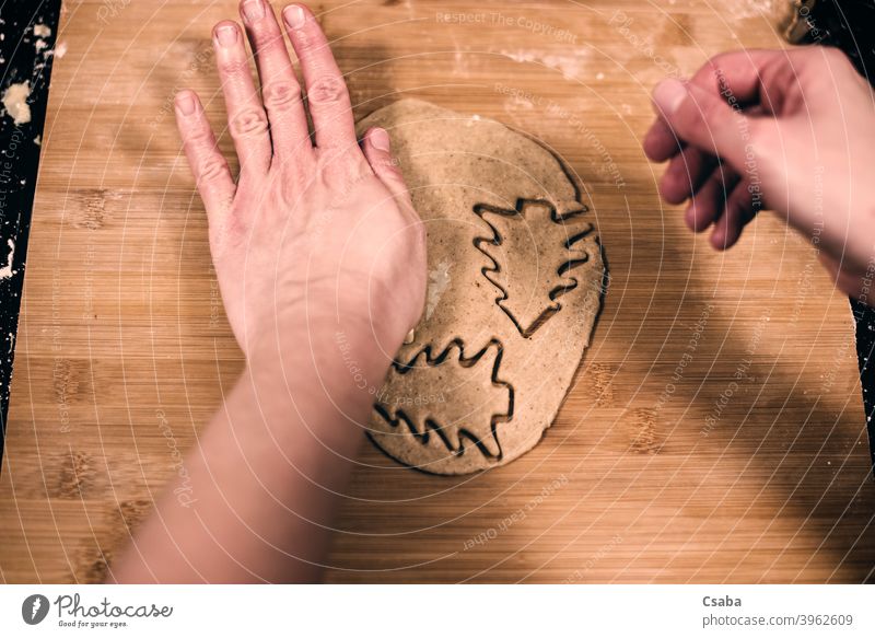 Top view of woman's hands making gingerbread preparing top homemade cookie sweet food raw dough dessert pastry christmas cutter traditional preparation kitchen