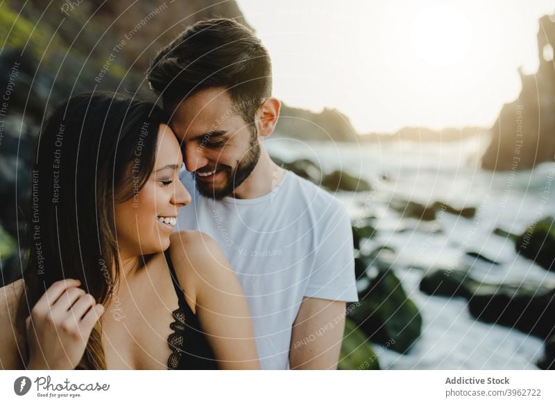 Affectionate young couple hugging on beach sea romantic love embrace coast together fondness happy tenerife island canary spain relationship affection tender