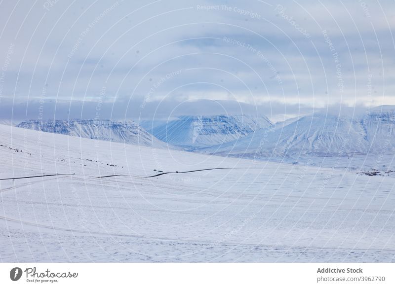 Curved road in mountains in winter curve snow roadway highland empty winding valley iceland landscape asphalt route scenic nature terrain environment weather