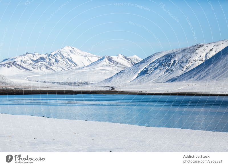 Lake in mountainous terrain in winter lake landscape pond highland sky blue snow white iceland majestic scenery scenic season calm tranquil environment water
