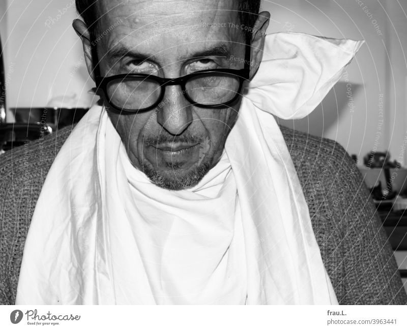 A fierce look over the edge flash Sweater Sit Eyeglasses Man Face portrait crease Facial hair Napkin Eating Meal