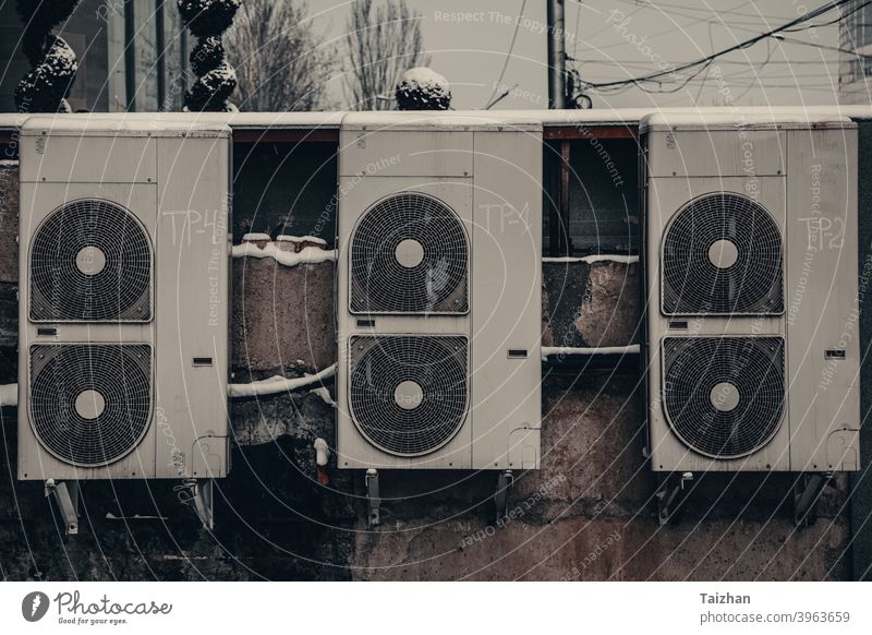 backside of the urban fashion store. dirty old air conditioners on a vintage  wall grunge cables distressed doors system unit and compressor fan grimy junk