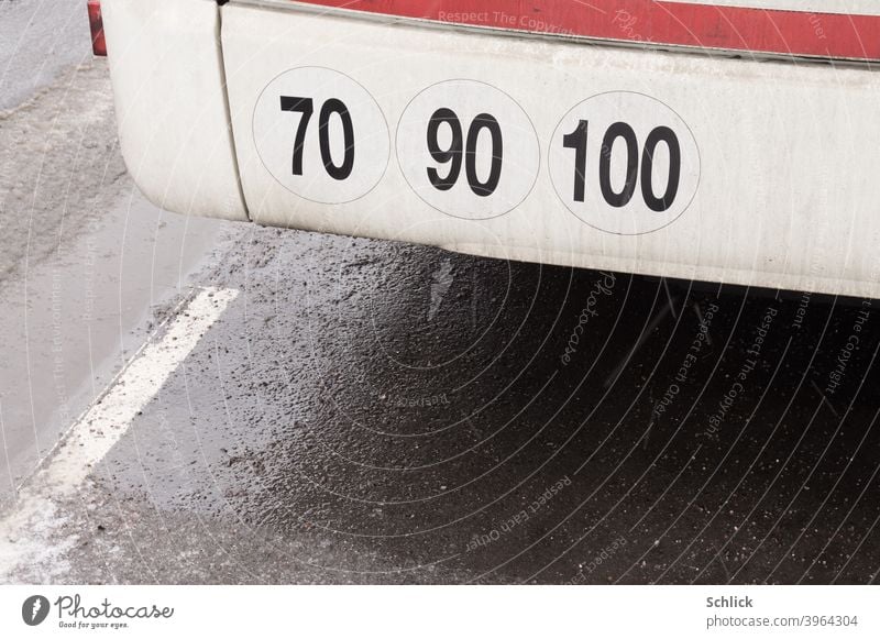 Notes sticker maximum speeds 70 90 100 kilometers per hour on the bumper of a bus Speed limit Bus Bumper Clue stickers kilometres per hour detail Close-up