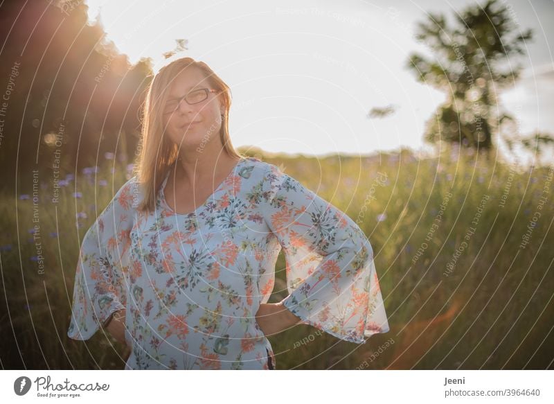 Young woman smiling friendly | Sunny summer evening with blue cornflowers in background | Portrait 30 - 45 years Woman feminine Smiling smilingly Feminine