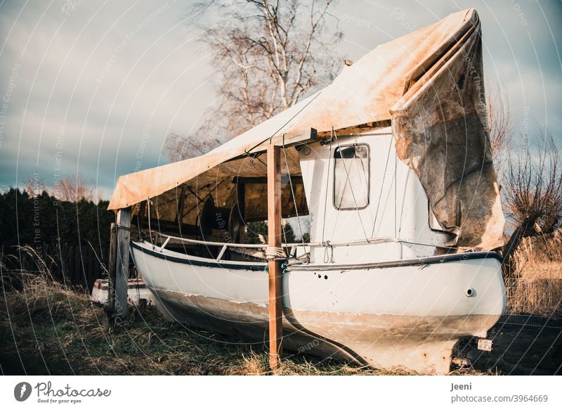 A fishing boat moored ashore for the winter in a small fishing harbour - a  Royalty Free Stock Photo from Photocase