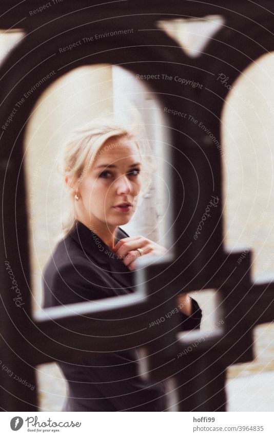 the young woman looks confidently into the camera, the railing serves as a ramen portrait Woman Looking into the camera melancholy Face Face of a woman