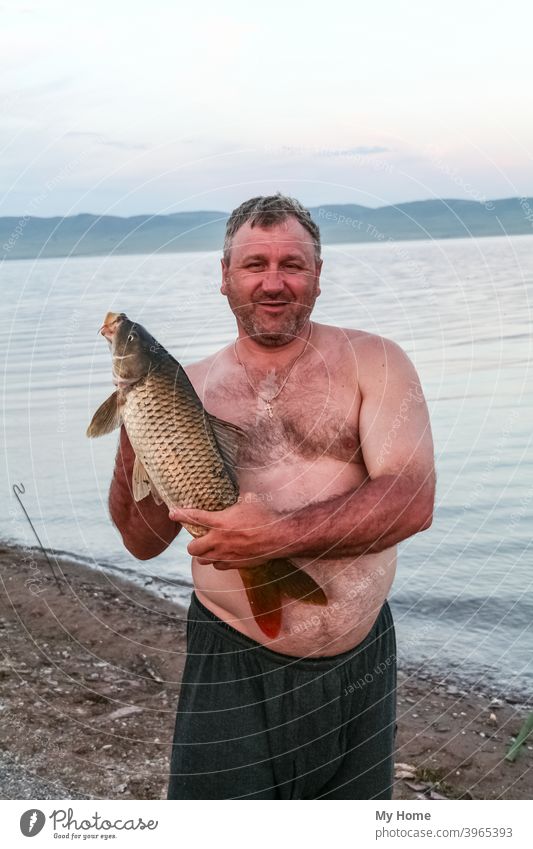 Two freshwater fish caught in a nylon net during ice fishing in Siberia  Stock Photo