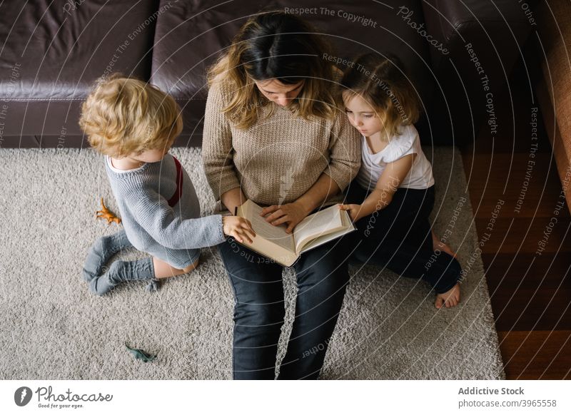 Mother reading book for kids at home mother sibling together fairytale children love lifestyle parent childhood story mom motherhood bonding parenthood