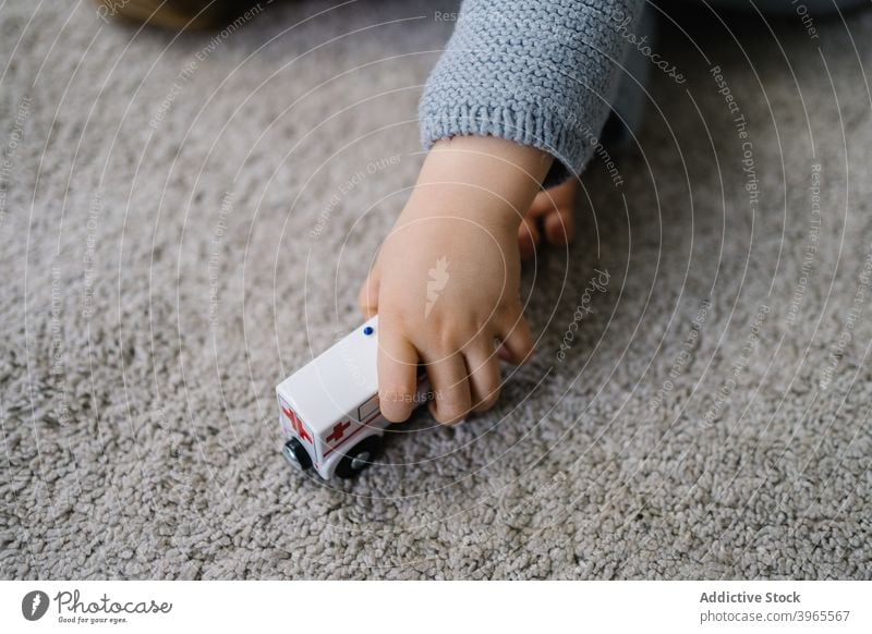 Happy kid playing with toy at home boy child game car activity happy cute little lying childhood lifestyle preschool free time childcare enjoy recreation